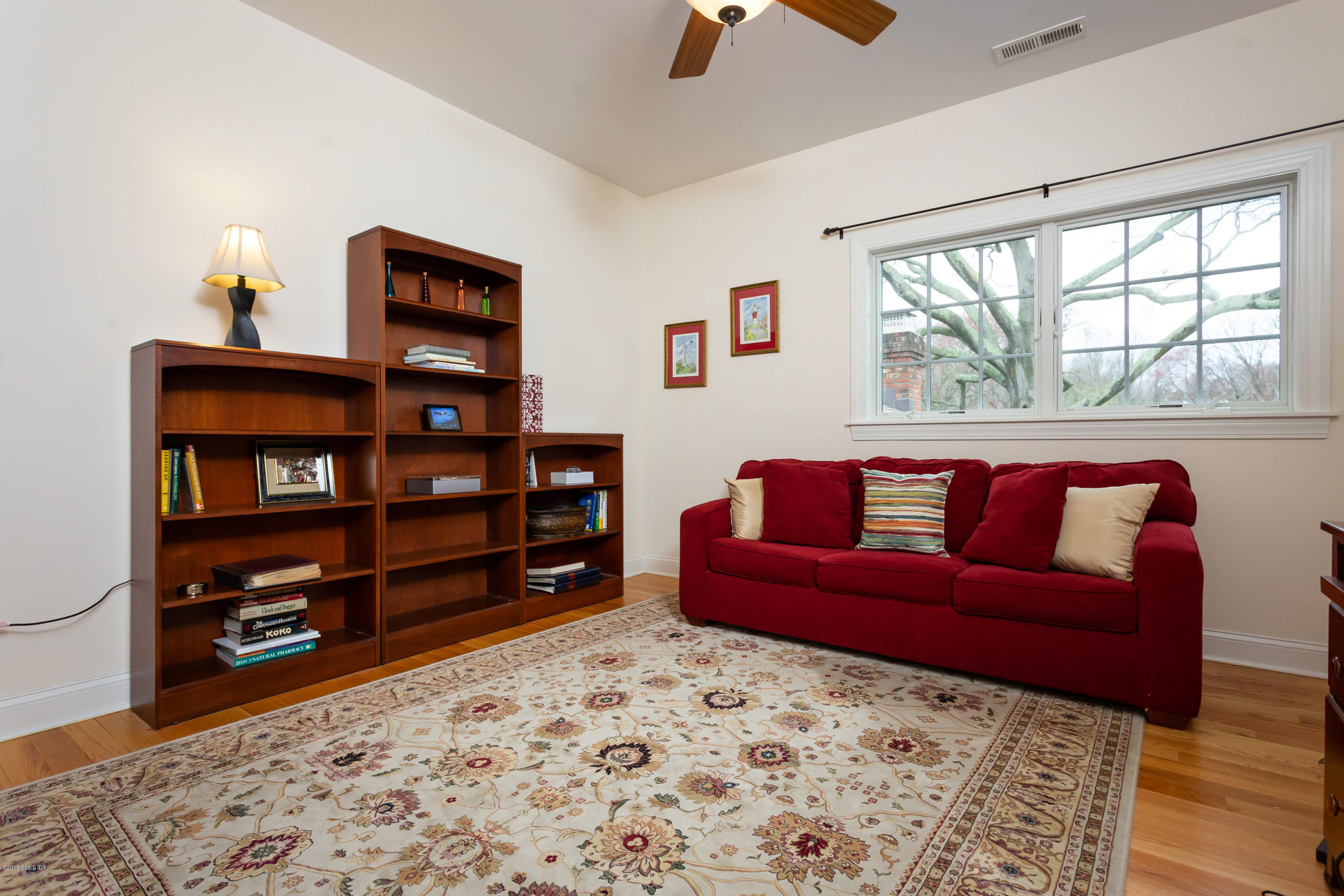 11 Tory Road Riverside, CT 06878 - Photo 20 of 29 a living room with a couch and a bookshelf