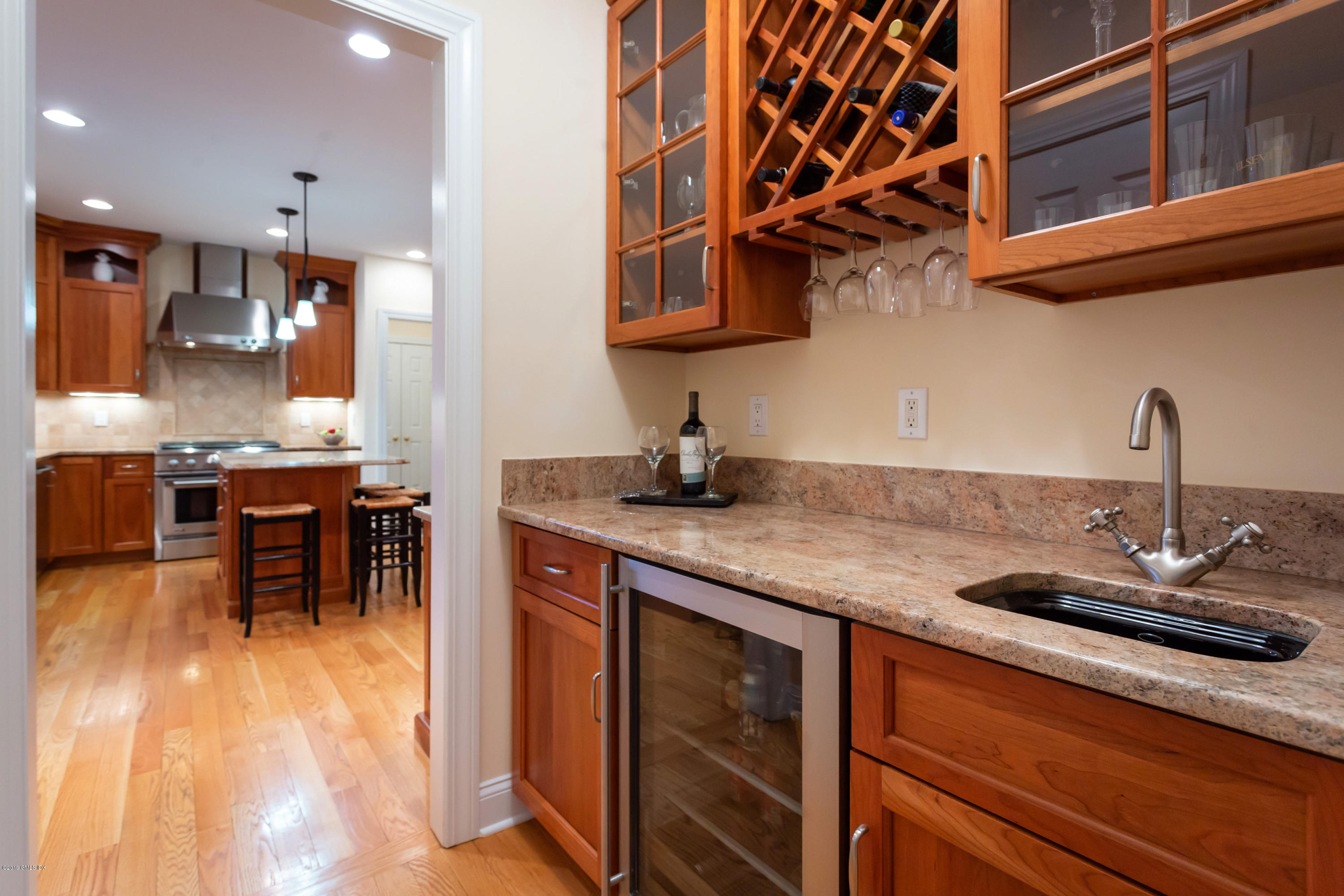 11 Tory Road Riverside, CT 06878 - Photo 5 of 29 a kitchen with stainless steel appliances granite countertop a sink dishwasher and a stove with wooden floor