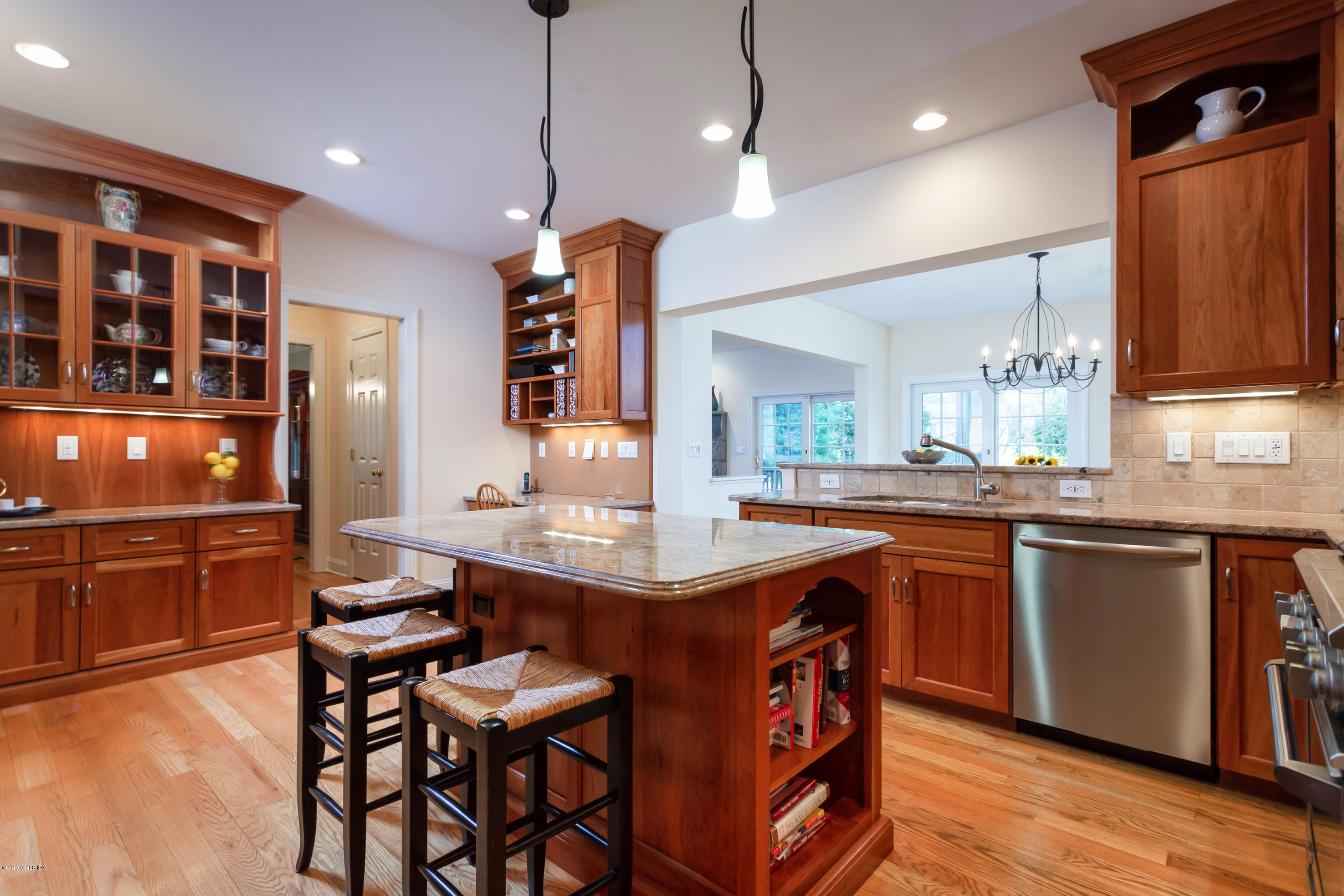 11 Tory Road Riverside, CT 06878 - Photo 8 of 29 a kitchen with stainless steel appliances granite countertop a stove a refrigerator a sink a dining table and chairs with wooden floor