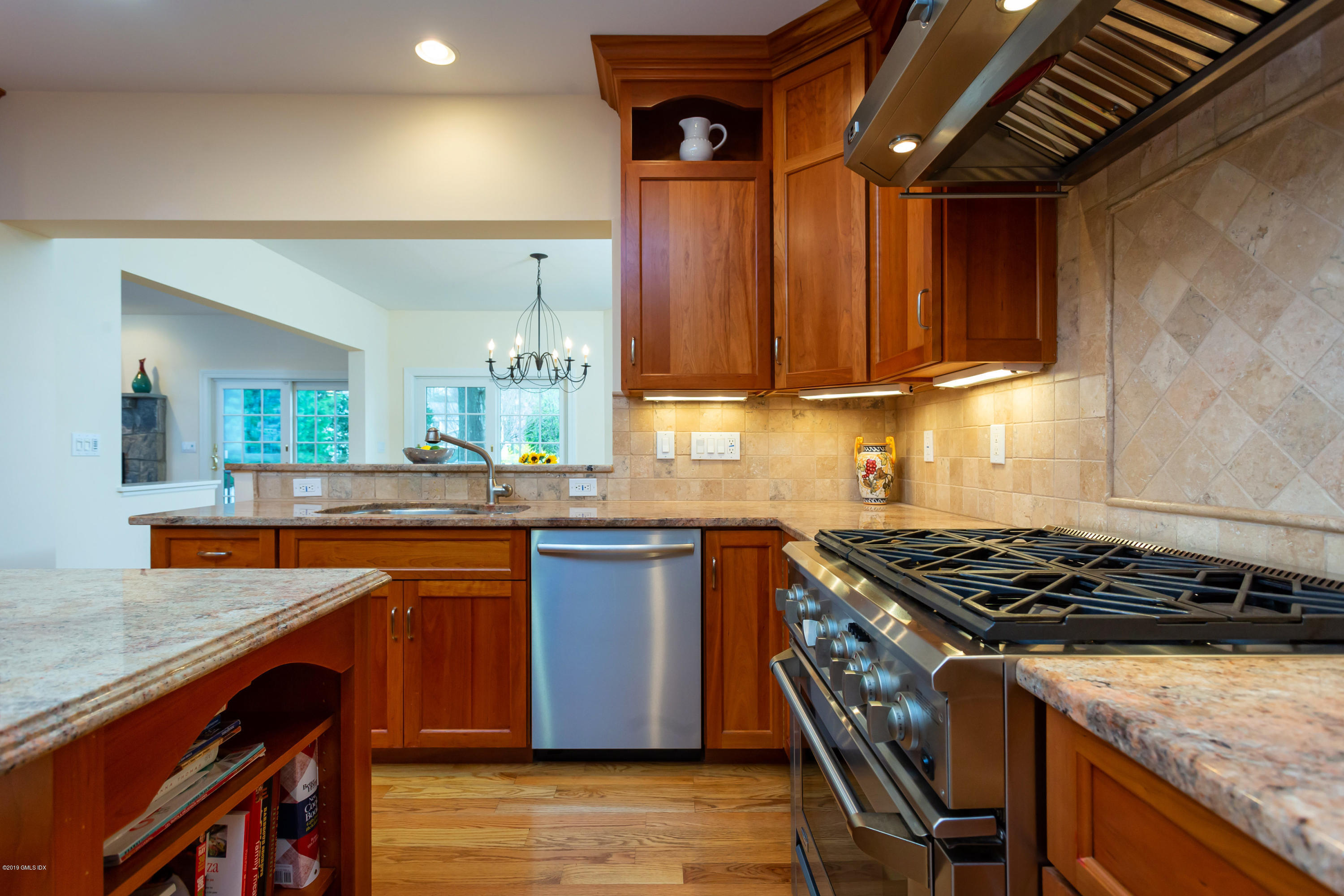 11 Tory Road Riverside, CT 06878 - Photo 9 of 29 a kitchen with stainless steel appliances granite countertop a stove a sink dishwasher and cabinets with wooden floor
