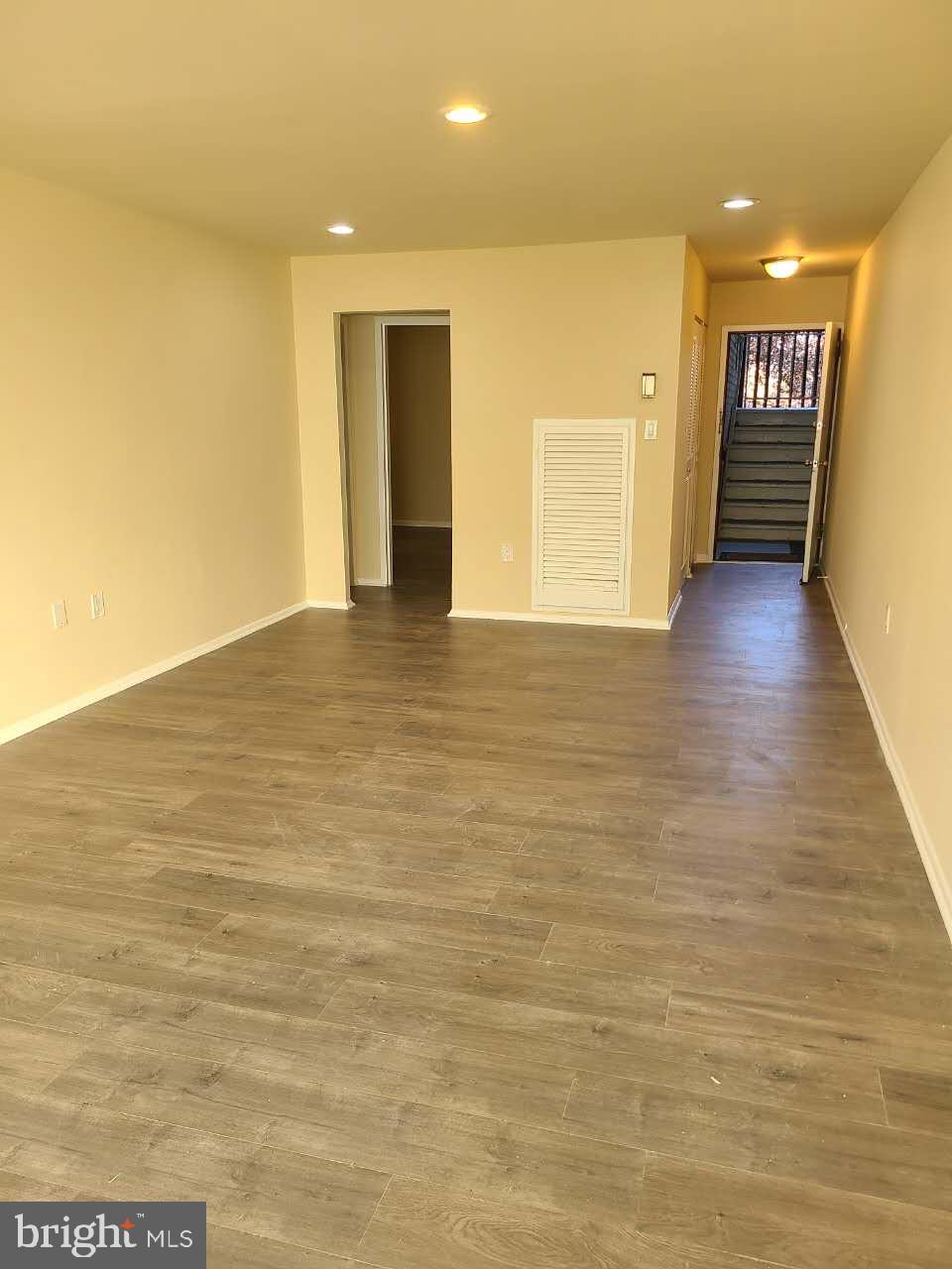 8685 Greenbelt Road, Unit 102 Greenbelt, MD 20770 - Photo 14 of 15 a view of an empty room with wooden floor and a window