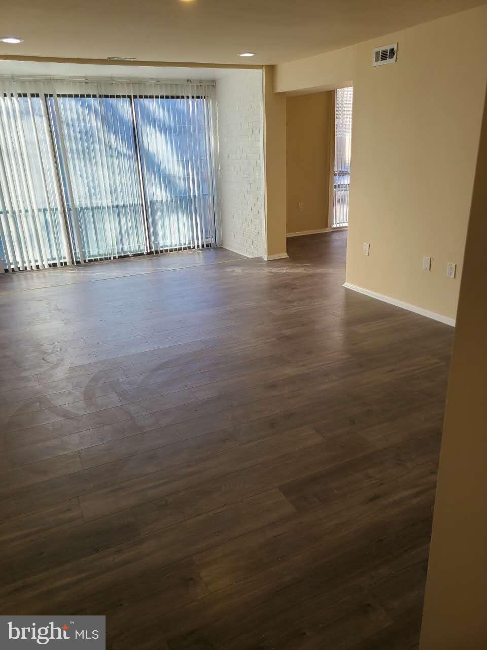 8685 Greenbelt Road, Unit 102 Greenbelt, MD 20770 - Photo 2 of 15 a view of an empty room with wooden floor