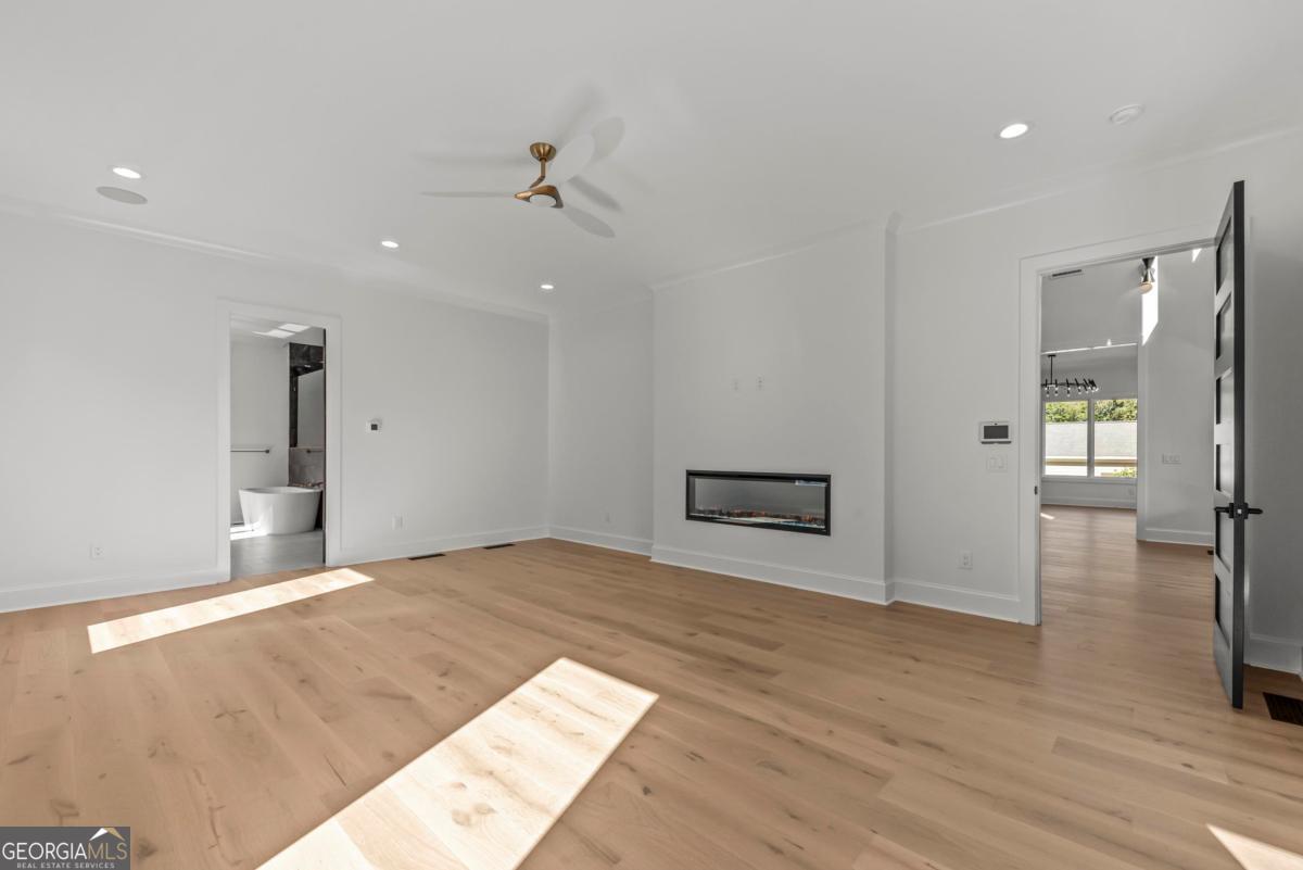 1089 B Crooked Creek Road Eatonton, GA 31024 - Photo 22 of 74 a view of an empty room with wooden floor and a bathroom