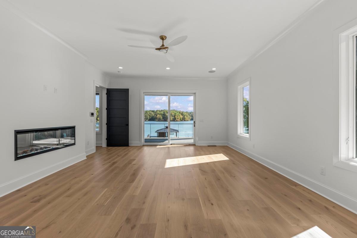 1089 B Crooked Creek Road Eatonton, GA 31024 - Photo 23 of 74 wooden floor in an empty room with a window