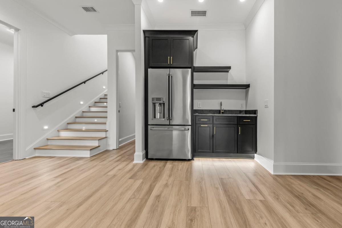 1089 B Crooked Creek Road Eatonton, GA 31024 - Photo 33 of 74 a kitchen with wooden floor and electronic appliances
