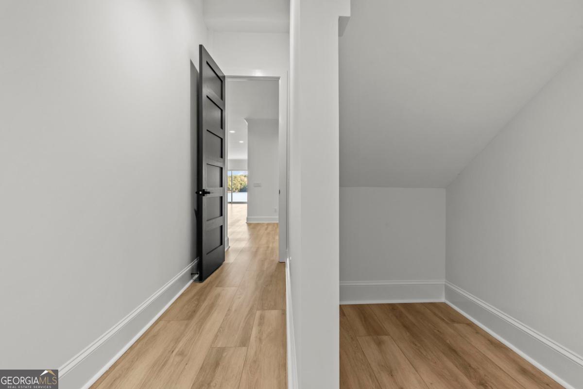1089 B Crooked Creek Road Eatonton, GA 31024 - Photo 36 of 74 a view of a hallway with wooden floor