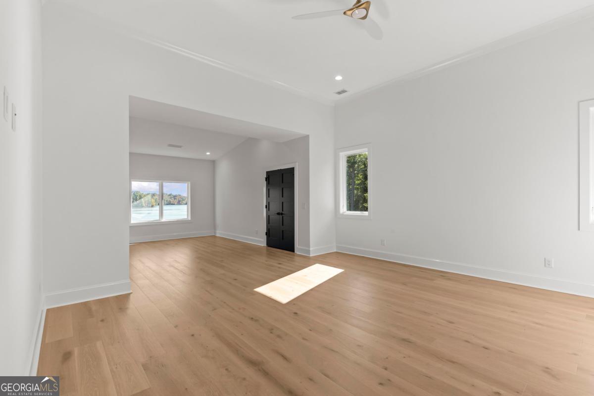 1089 B Crooked Creek Road Eatonton, GA 31024 - Photo 50 of 74 an empty room with wooden floor and windows