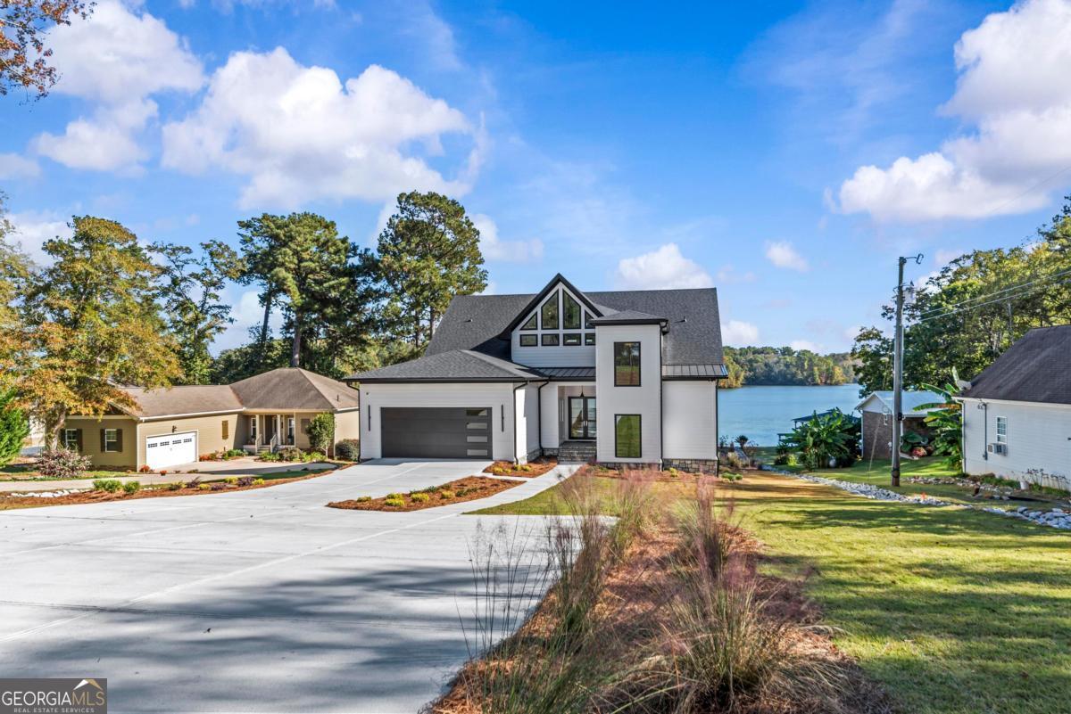 1089 B Crooked Creek Road Eatonton, GA 31024 - Photo 61 of 74 a front view of a house with a garden and fountain