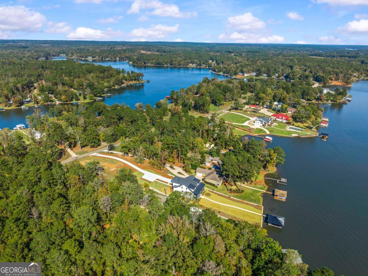 1089 B Crooked Creek Road Eatonton, GA 31024 - Photo 70 of 74 a view of a lake with a yard