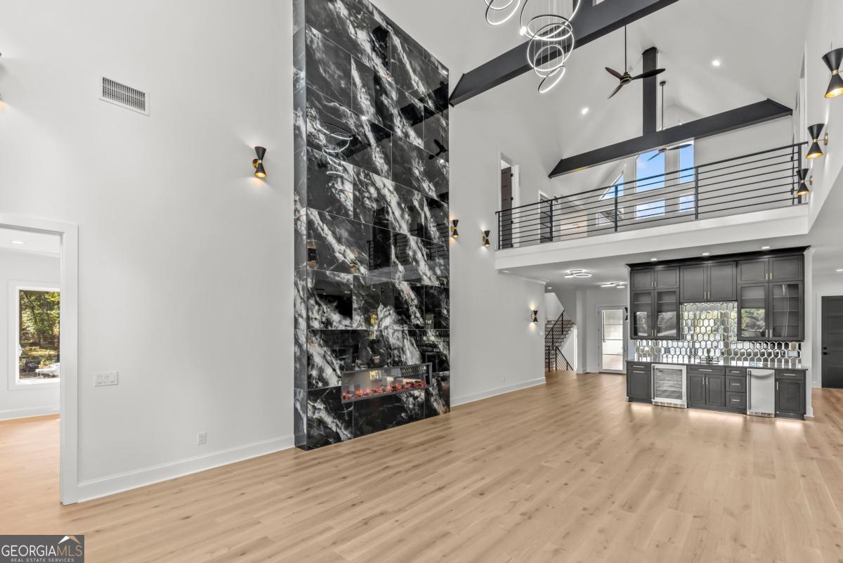 1089 B Crooked Creek Road Eatonton, GA 31024 - Photo 8 of 74 an empty room with wooden floor and a fireplace