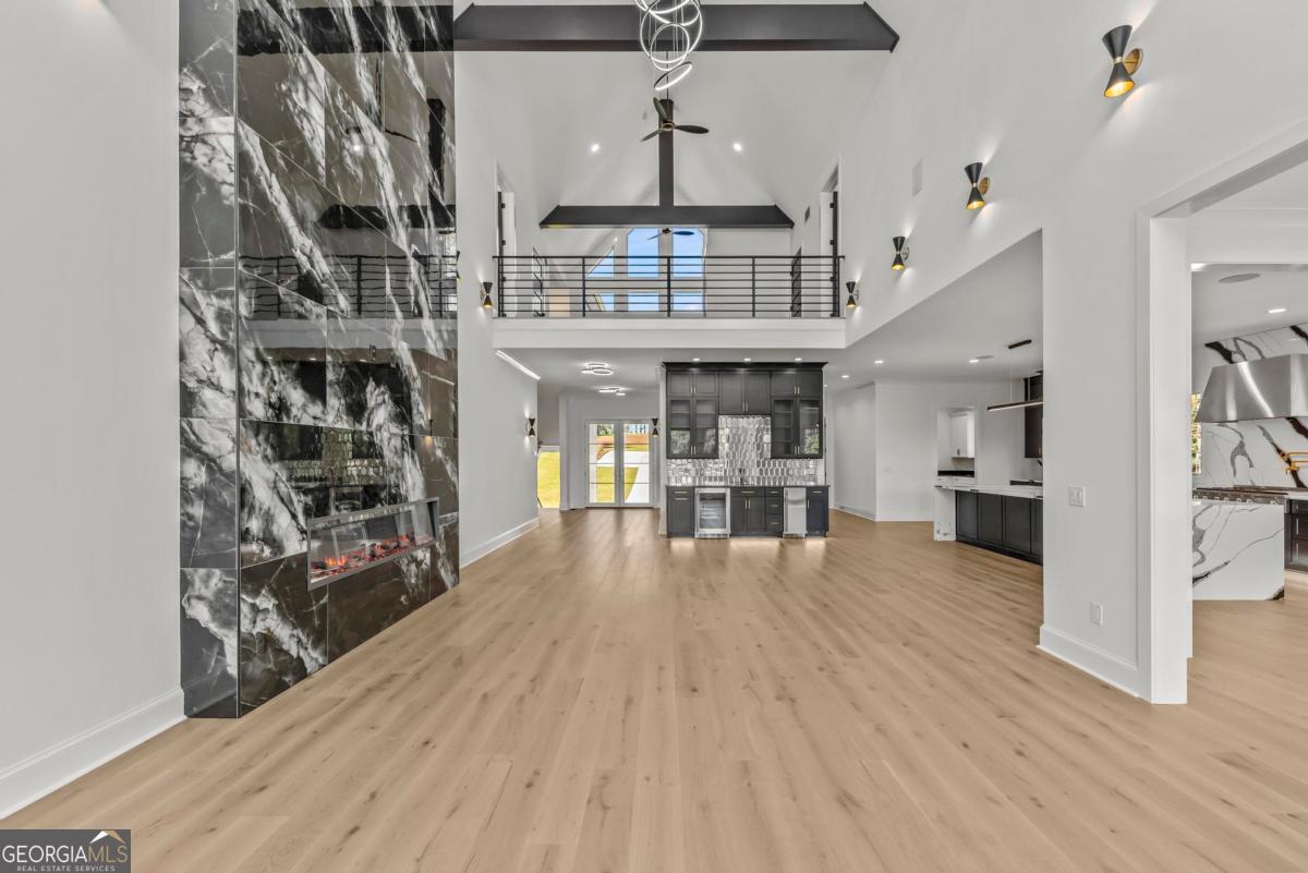 1089 B Crooked Creek Road Eatonton, GA 31024 - Photo 9 of 74 a view of a living room and kitchen with furniture wooden floor and window