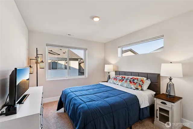 a bathroom with a double vanity sink mirror and toilet