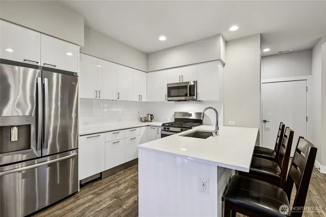 a kitchen with a sink appliances and a counter top space