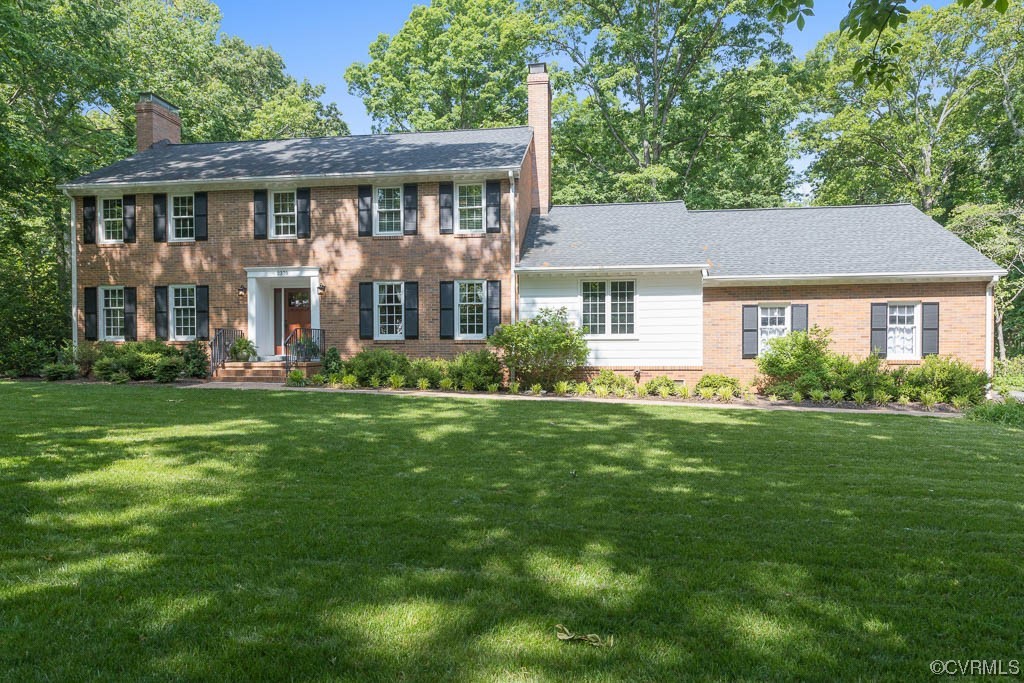 a front view of house with yard and green space