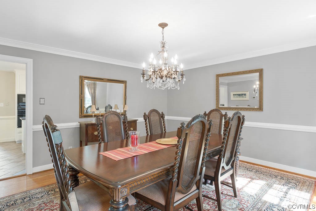 2370 Castlebridge Road Midlothian, VA 23113 - Photo 7 of 47 a dining room with furniture a chandelier and window