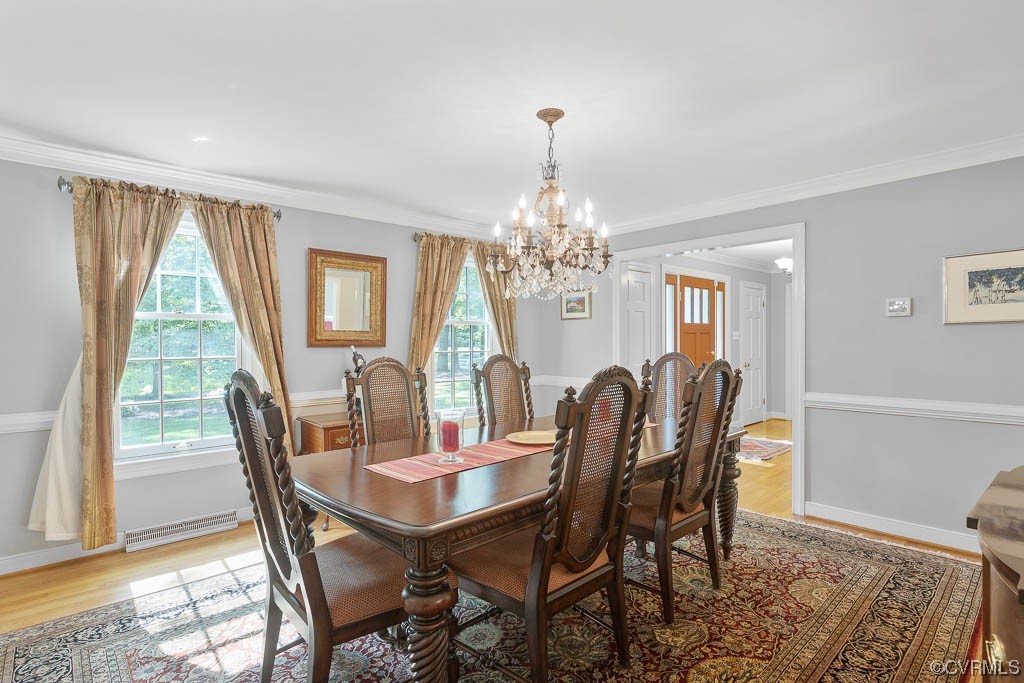 2370 Castlebridge Road Midlothian, VA 23113 - Photo 8 of 47 a view of a dining room with furniture a chandelier and wooden floor