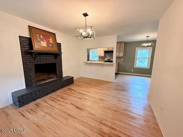a view of a kitchen stove and wooden floor