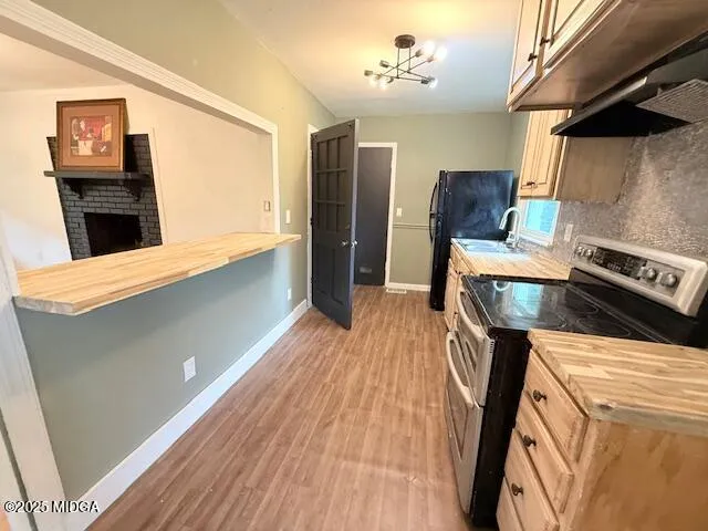 a kitchen with granite countertop a stove and a sink