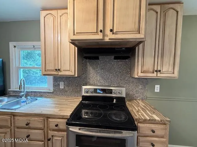 a kitchen with stainless steel appliances a sink stove and cabinets