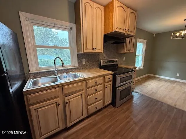 a view of a kitchen with a sink wooden floor and a window