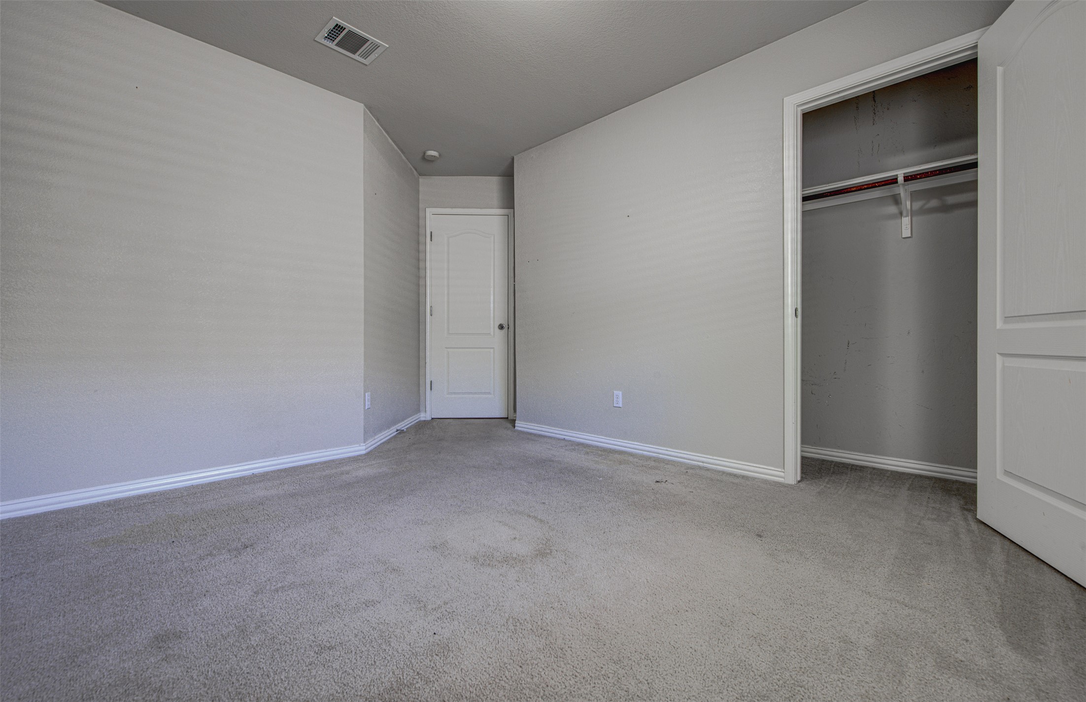 2090 Intrepid Drive Buda, TX 78610 - Photo 19 of 24 Unfurnished bedroom featuring carpet and a closet