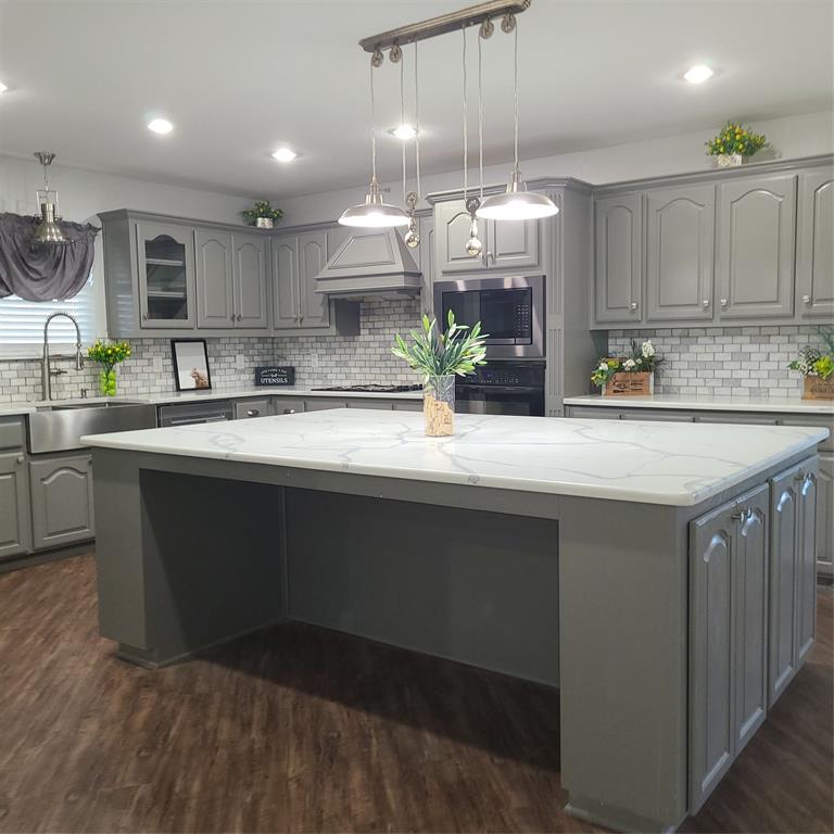 406 Epps Road Palmer, TX 75152 - Photo 14 of 40 Quartz counters, oversized island with seating on both sides and storage on both ends, stainless farmhouse sink.