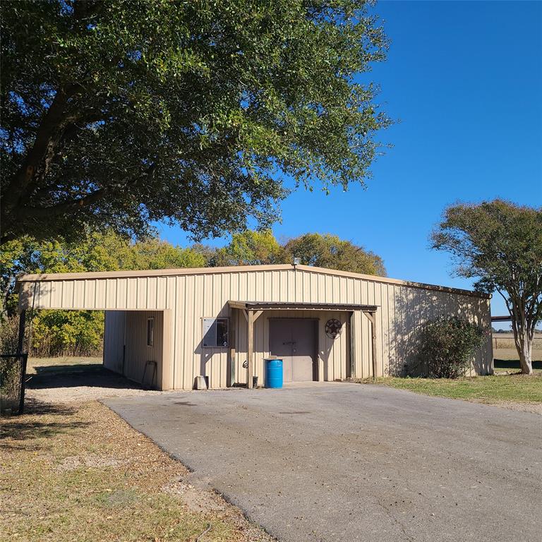 406 Epps Road Palmer, TX 75152 - Photo 4 of 40 30×40 workshop with additional carport and double steel entry doors.