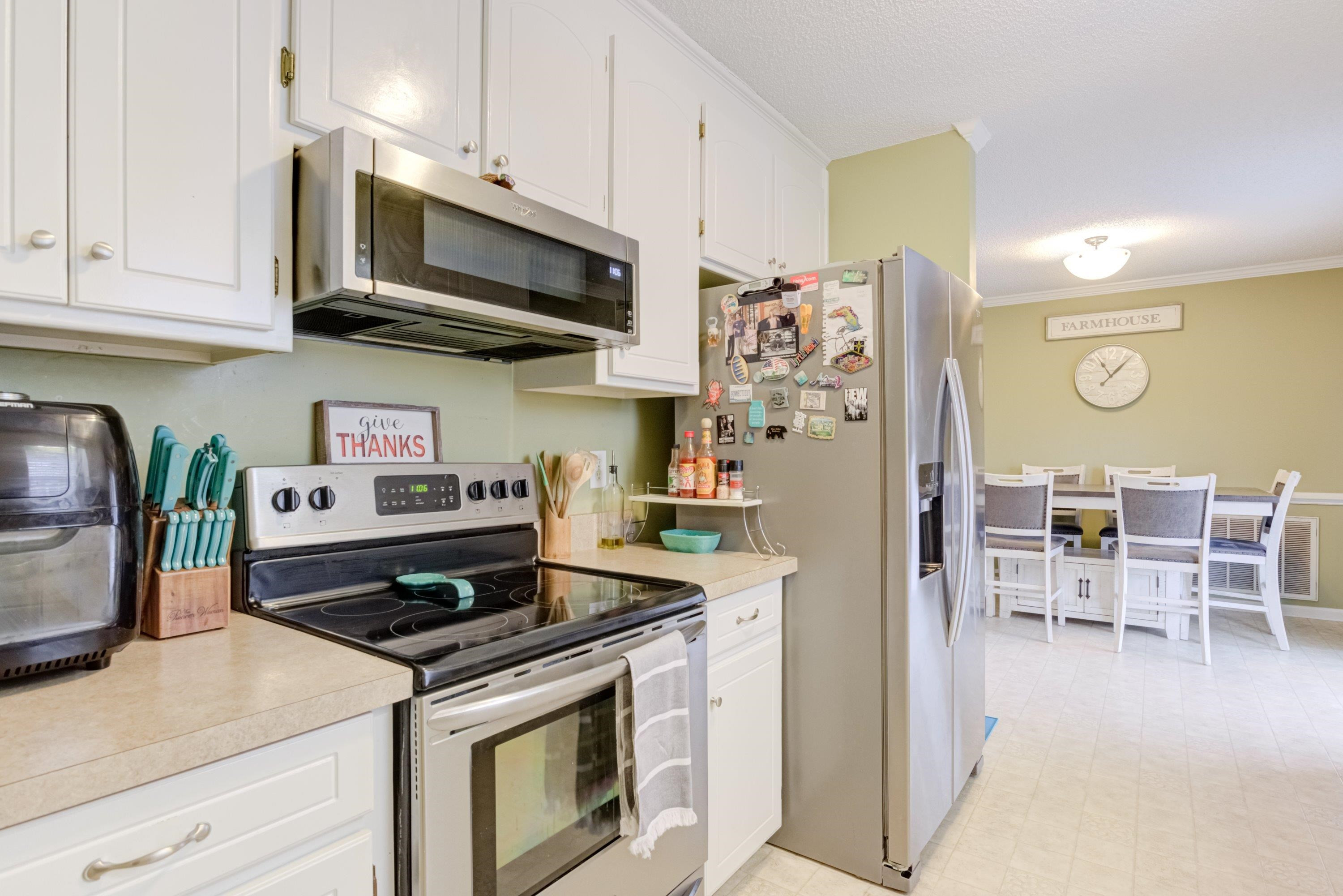 4245 Bizzell Grove Church Road Princeton, NC 27569 - Photo 14 of 30 a kitchen with stainless steel appliances granite countertop a stove a refrigerator and a microwave