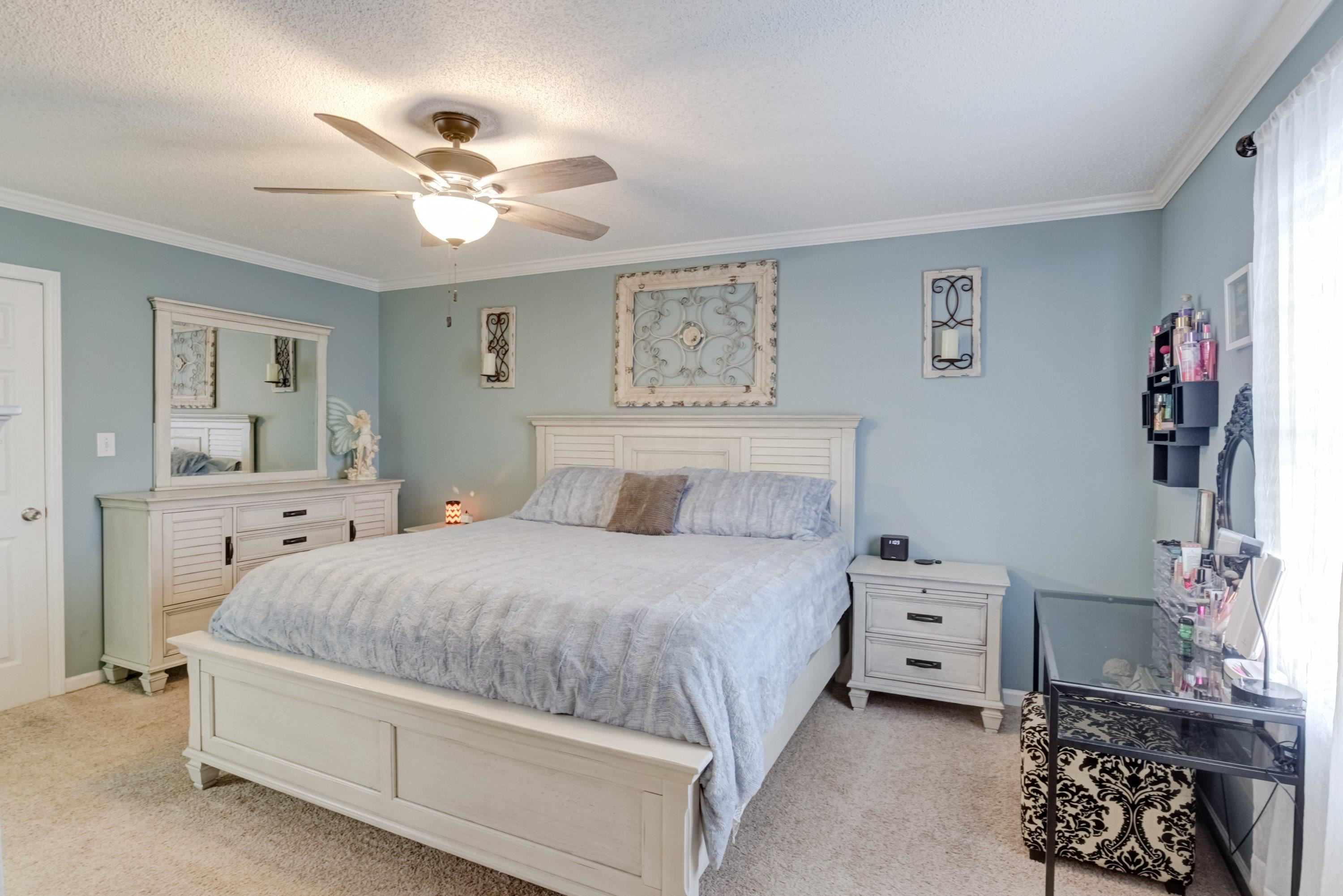 4245 Bizzell Grove Church Road Princeton, NC 27569 - Photo 15 of 30 a bedroom with a bed and a chandelier