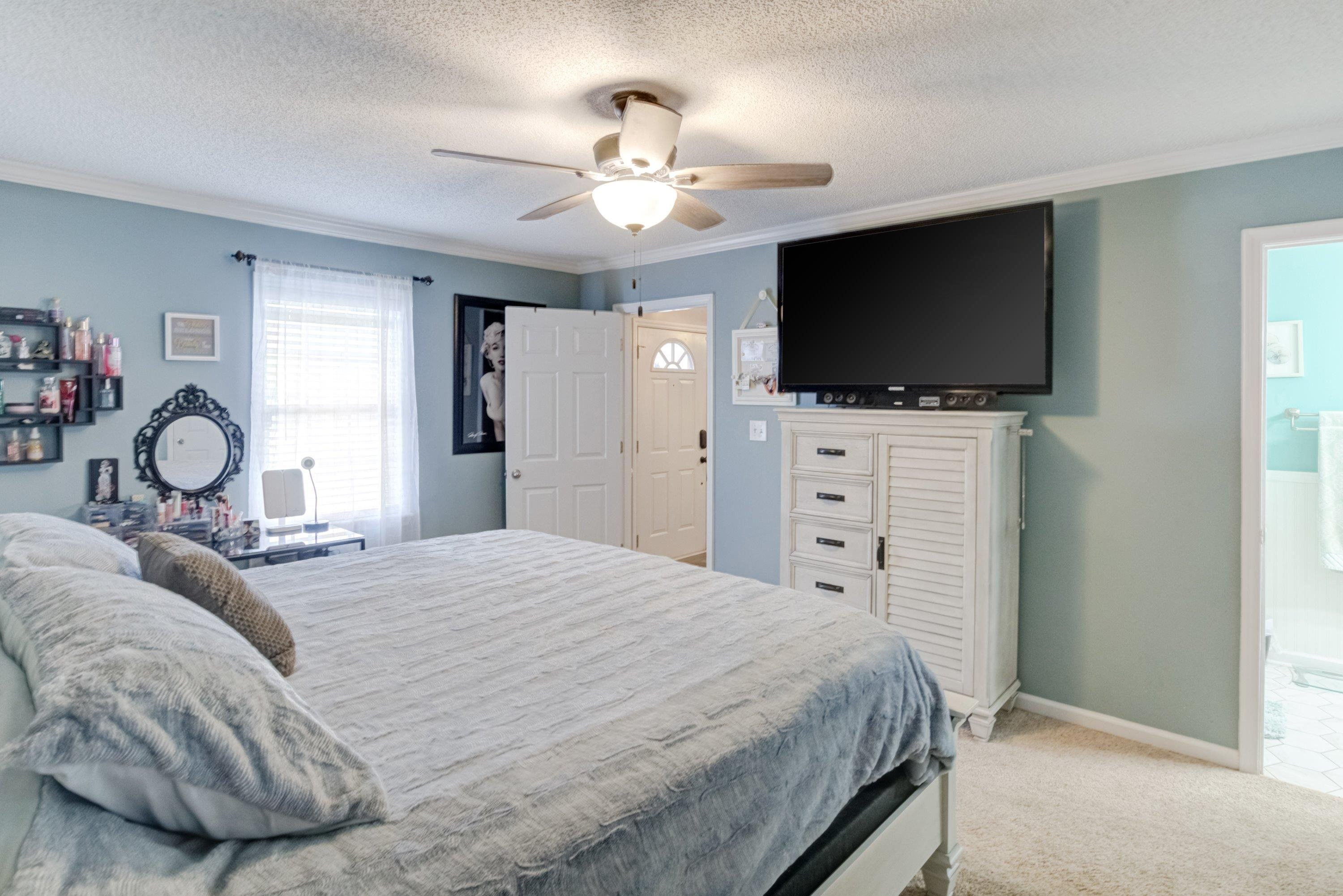 4245 Bizzell Grove Church Road Princeton, NC 27569 - Photo 17 of 30 a bedroom with a large bed and a flat tv screen on dresser