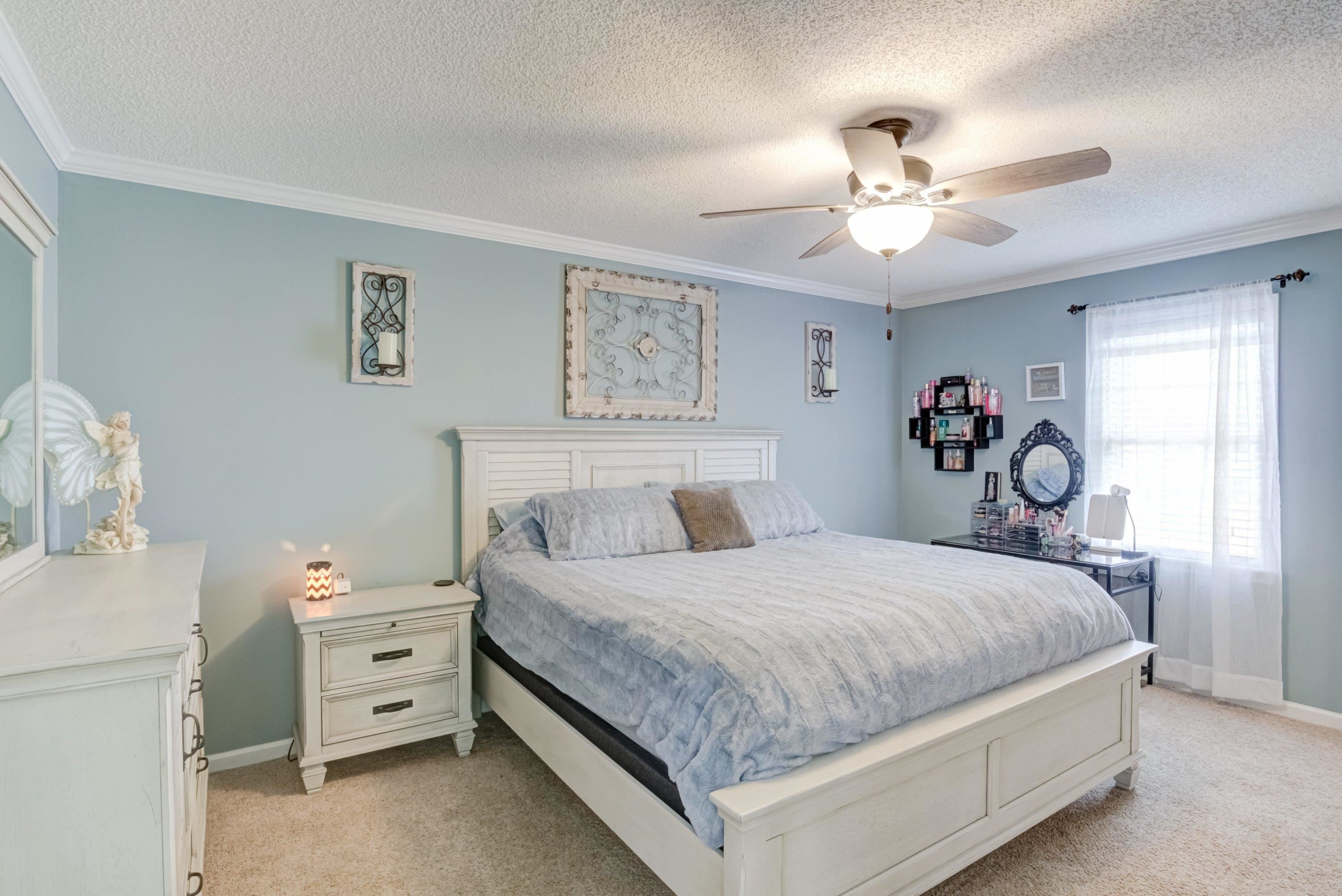 4245 Bizzell Grove Church Road Princeton, NC 27569 - Photo 18 of 30 a bedroom with a bed and a chandelier