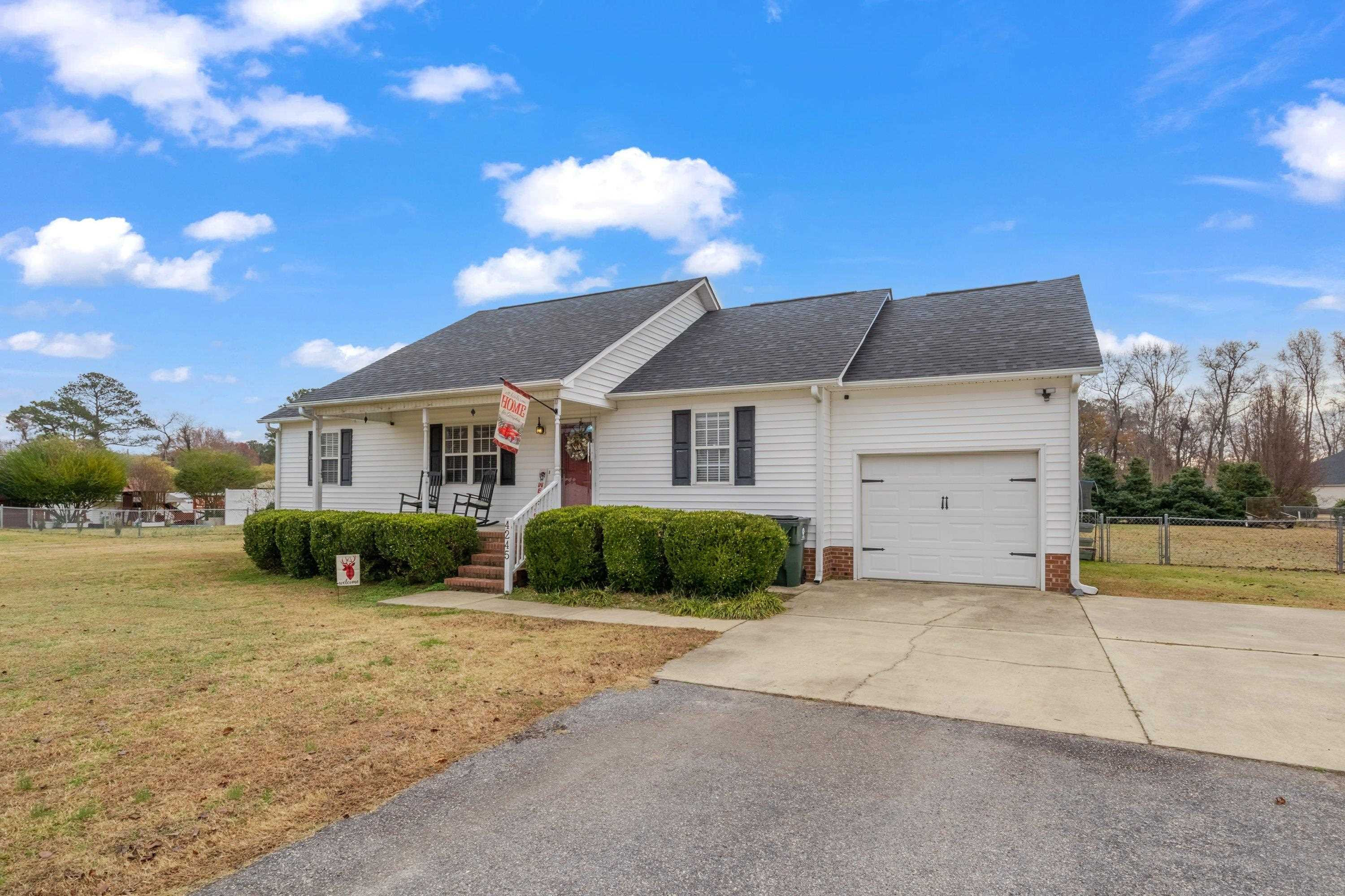4245 Bizzell Grove Church Road Princeton, NC 27569 - Photo 2 of 30 a front view of a house with a yard and garage