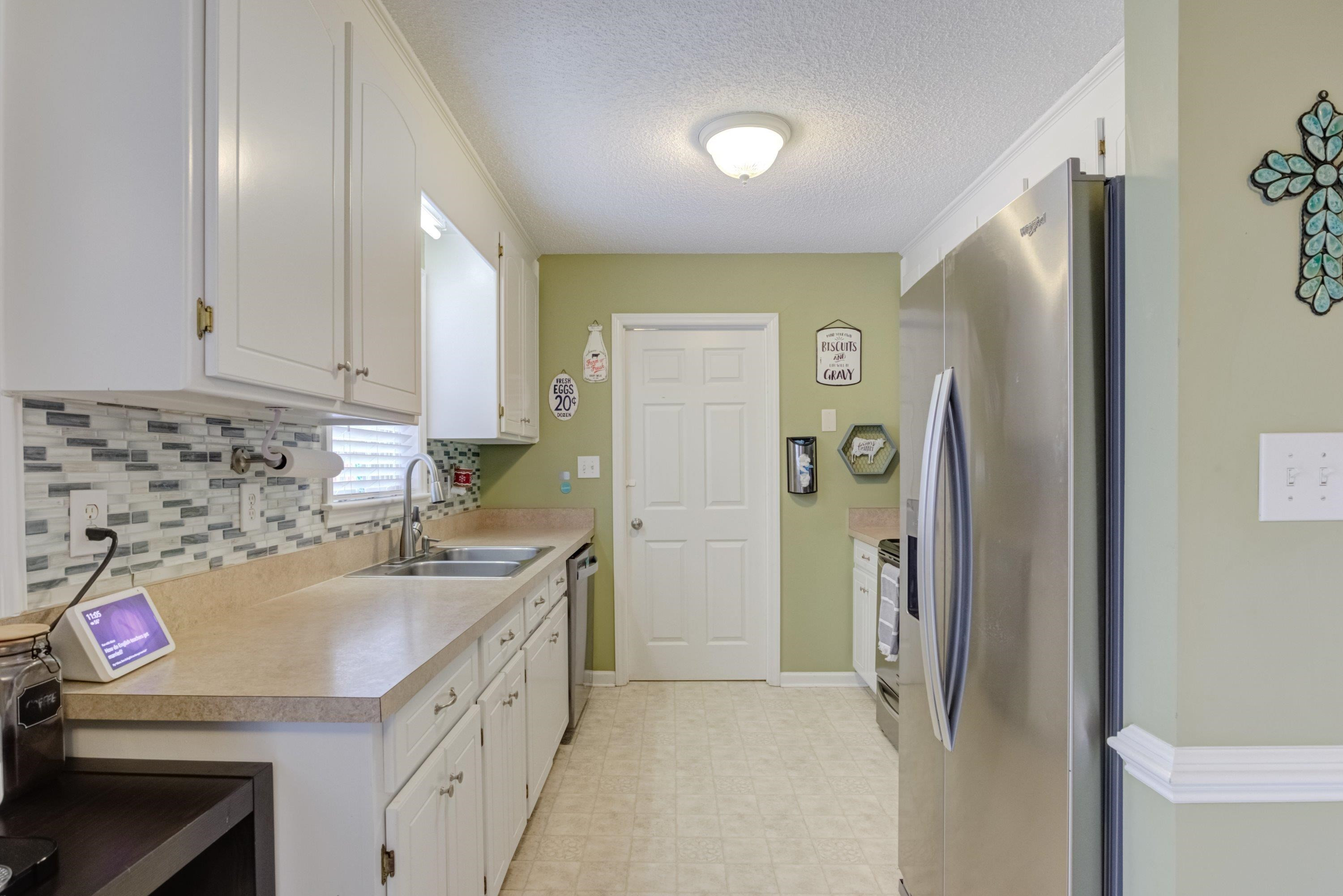 4245 Bizzell Grove Church Road Princeton, NC 27569 - Photo 10 of 30 a kitchen with a sink and a refrigerator