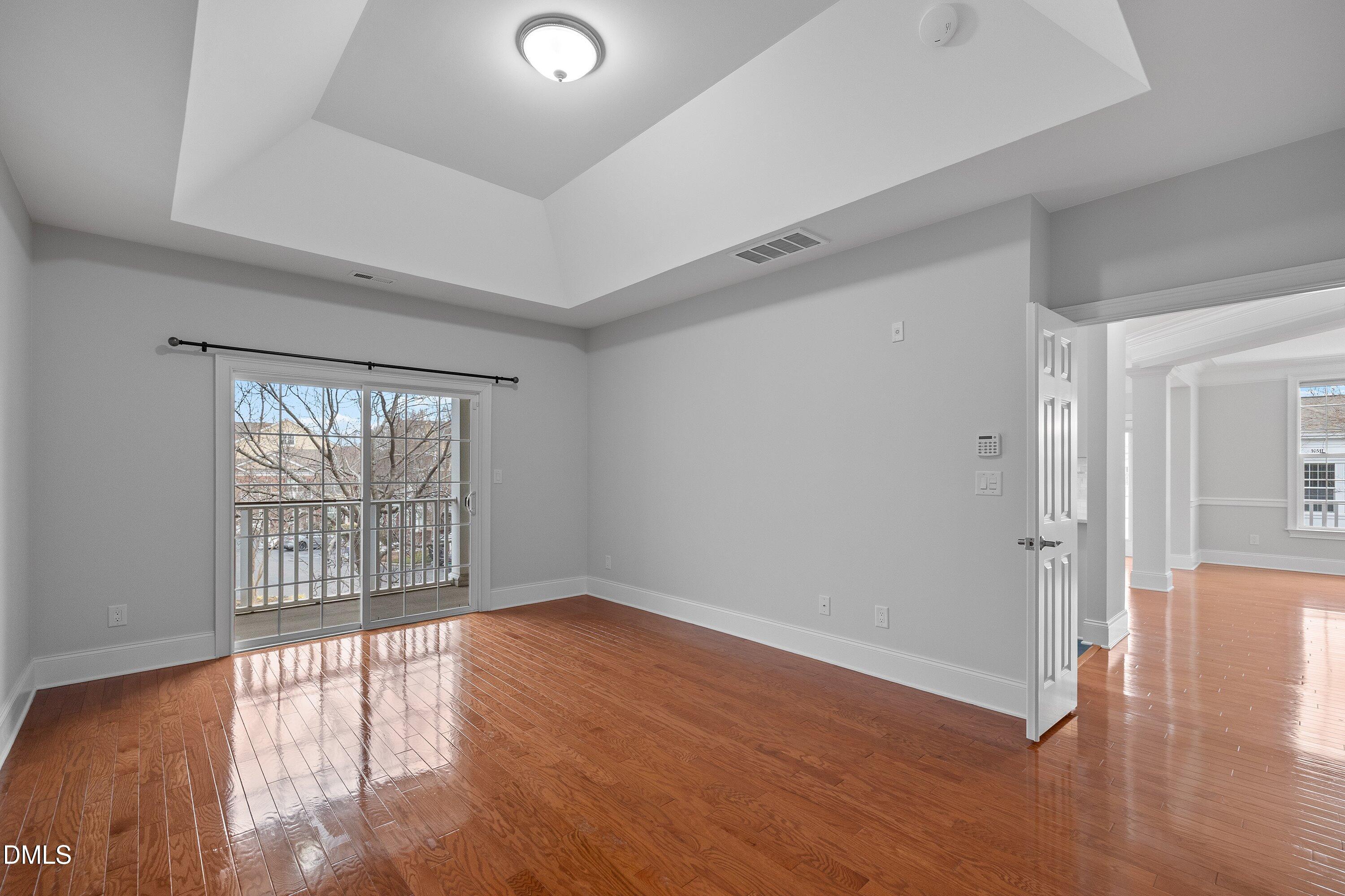 9211 Calabria Drive, Unit 205 Raleigh, NC 27617 - Photo 37 of 55 wooden floor in an empty room with a window