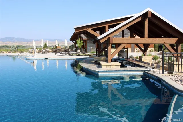 a front view of a house with swimming pool having outdoor seating