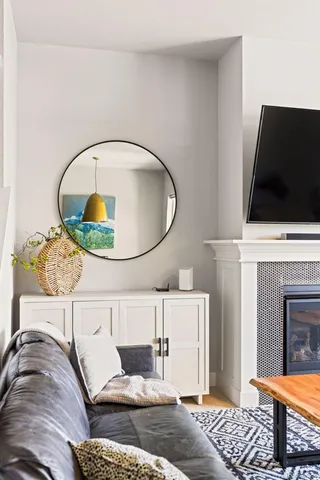 a living room with a fireplace furniture and a flat screen tv