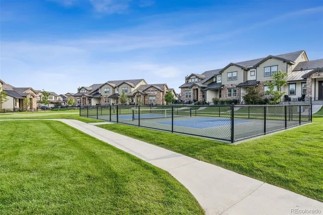 a view of a park with iron fence