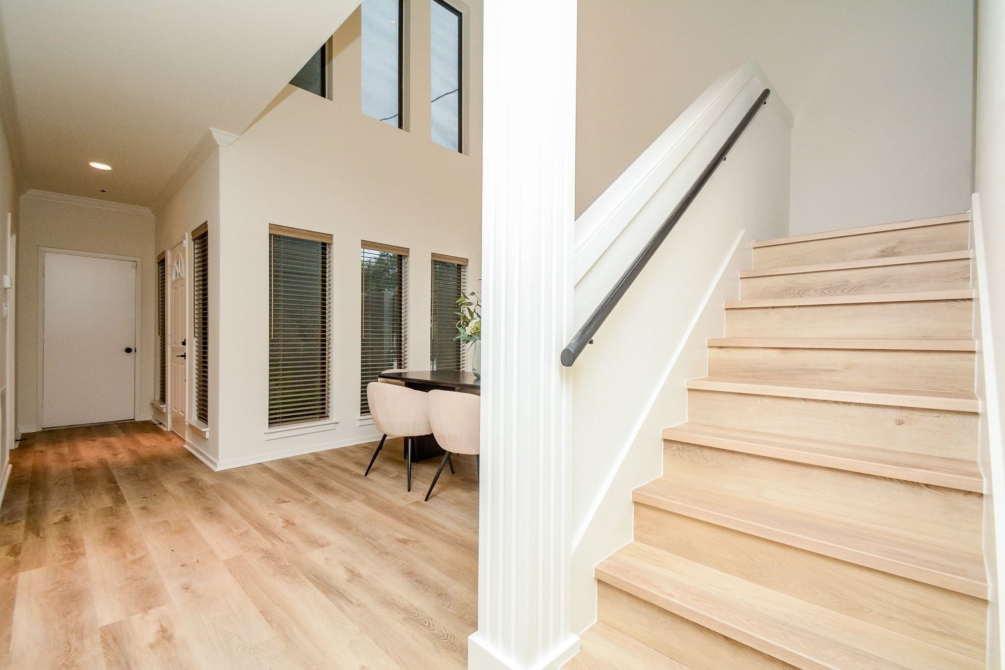 820 Harold Street Houston, TX 77006 - Photo 15 of 33 Wood-look treads and a sleek matte black handrail make a clean statement on the way up to the second floor.