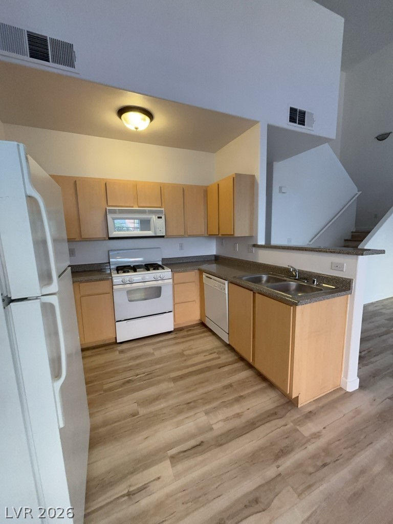 4915 East Russell Road, Unit 143 Las Vegas, NV 89120 - Photo 4 of 10 A well-appointed kitchen boasts ample cabinetry and practical counter space, flowing into an inviting open-concept layout.