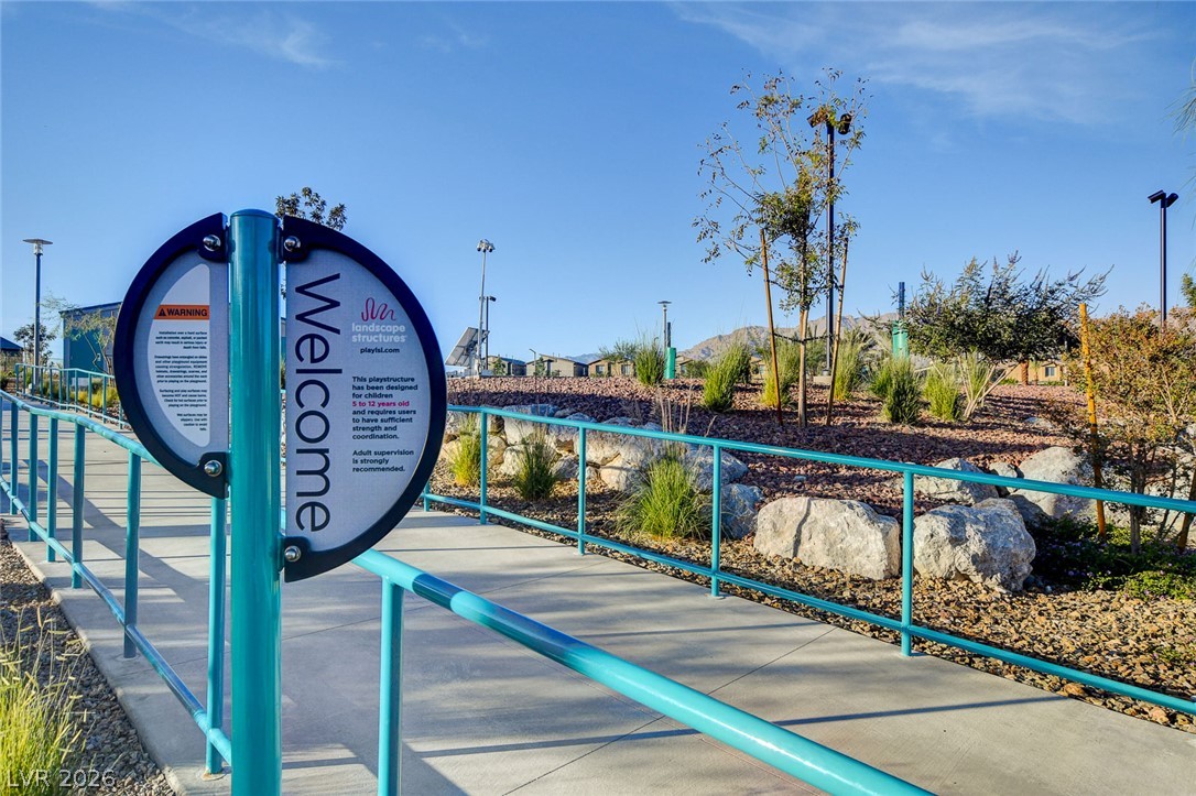 7330 North Decatur Boulevard, Unit 6 North Las Vegas, NV 89084 - Photo 35 of 42 A vibrant community park with a wide pathway and sturdy turquoise railings, perfect for leisurely strolls.