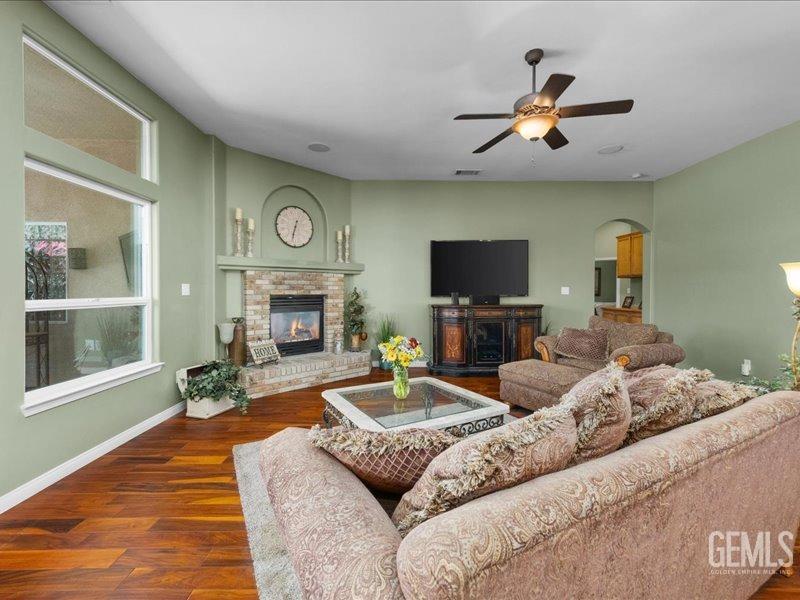 Undisclosed Address Bakersfield, CA 93314 - Photo 11 of 38 a living room with furniture a fireplace and a flat screen tv