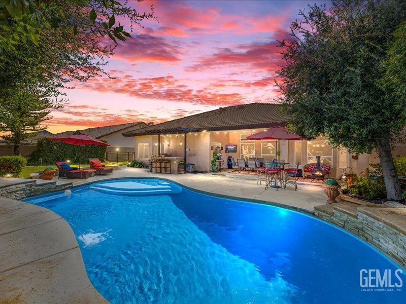 Undisclosed Address Bakersfield, CA 93314 - Photo 2 of 38 a view of swimming pool with outdoor seating and a garden