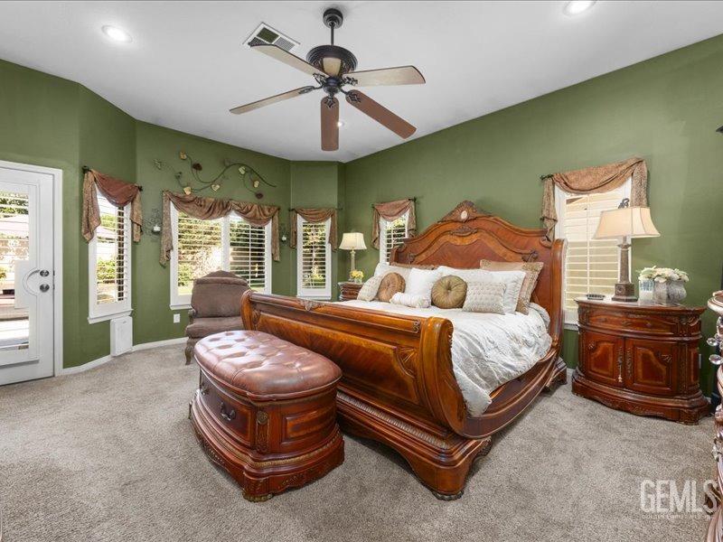 Undisclosed Address Bakersfield, CA 93314 - Photo 21 of 38 a spacious bedroom with a bed and ceiling fan