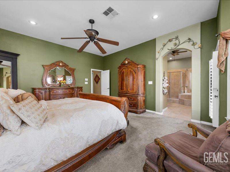 Undisclosed Address Bakersfield, CA 93314 - Photo 23 of 38 a bed room with a bed mirror and a chandelier