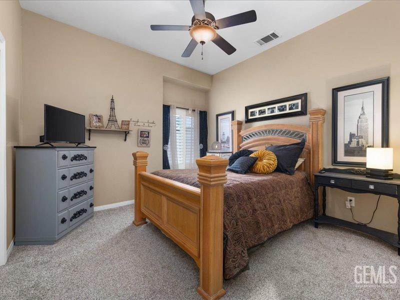 Undisclosed Address Bakersfield, CA 93314 - Photo 26 of 38 a bedroom with a bed and dresser with mirror