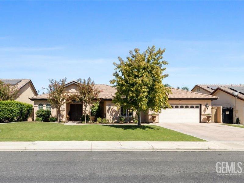 Undisclosed Address Bakersfield, CA 93314 - Photo 3 of 38 a front view of a house with a yard and trees