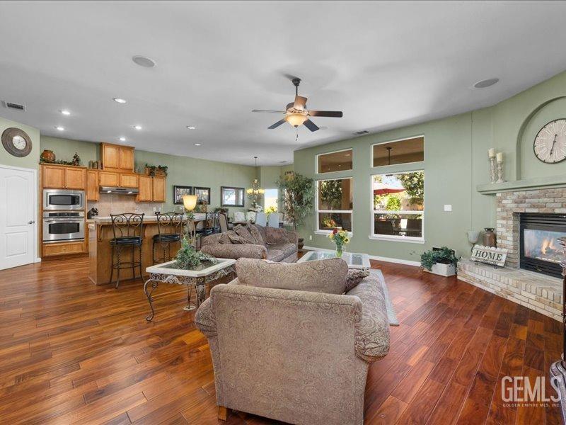 Undisclosed Address Bakersfield, CA 93314 - Photo 9 of 38 a living room with furniture kitchen view and a wooden floor