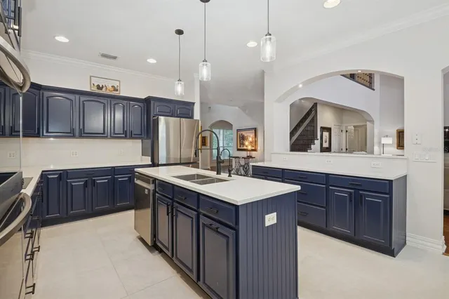 a view of a dining room with furniture a chandelier and wooden floor