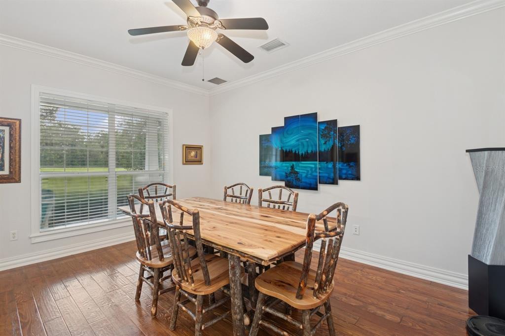 35520 Timbertop Lane Fruitland Park, FL 34731 - Photo 17 of 82 a view of a dining room with furniture window and wooden floor