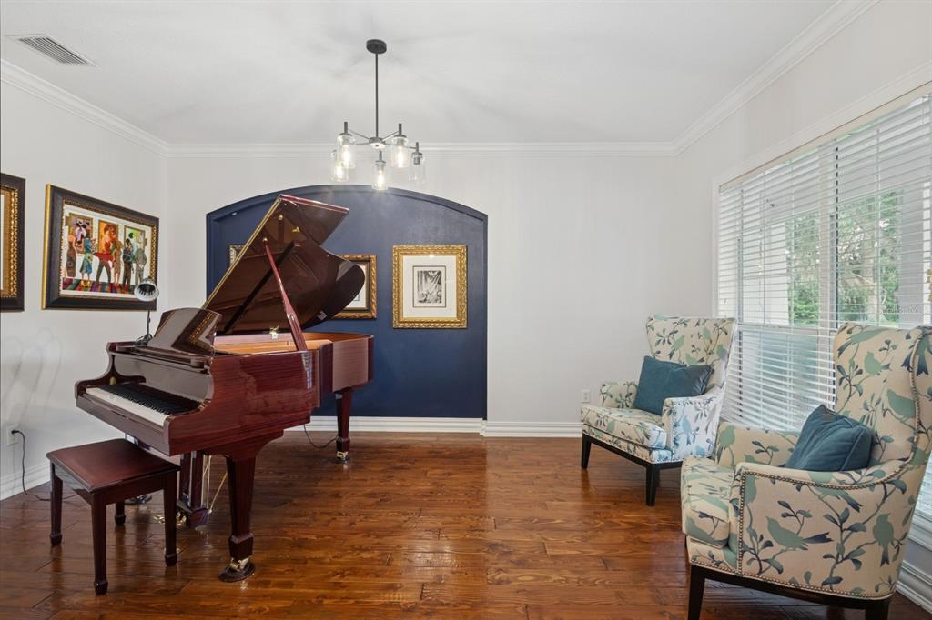 35520 Timbertop Lane Fruitland Park, FL 34731 - Photo 18 of 82 a living room with furniture a piano and a window